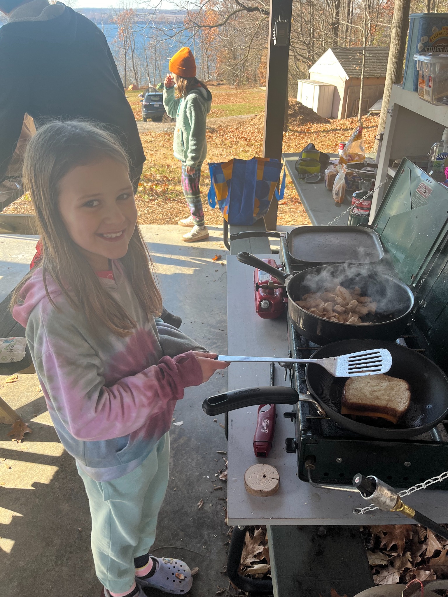 A Troop 33 Scout cooking breakfast on a camp stove during an outdoor outing